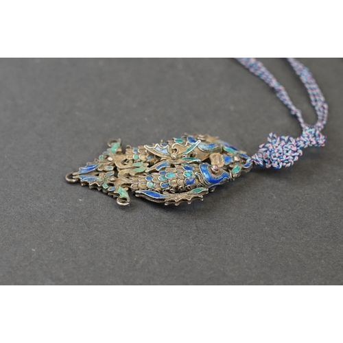 274 - A vintage Chinese white metal and enamel double fish pendant on hand knotted silk chain.