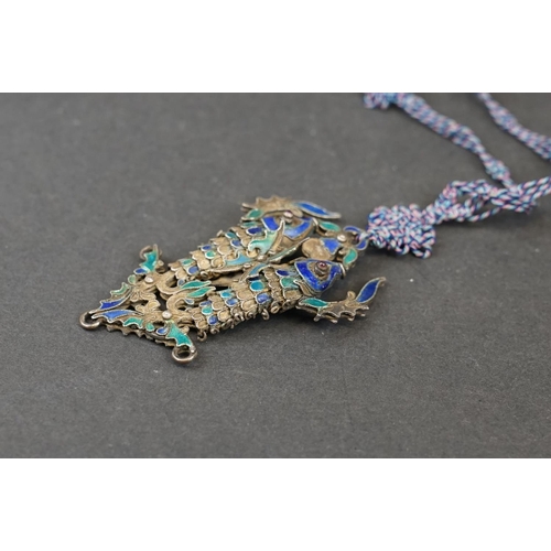 274 - A vintage Chinese white metal and enamel double fish pendant on hand knotted silk chain.