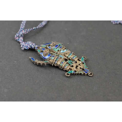 274 - A vintage Chinese white metal and enamel double fish pendant on hand knotted silk chain.