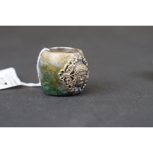 288 - A vintage Tibetan jade ring with white metal mount together with another similar.