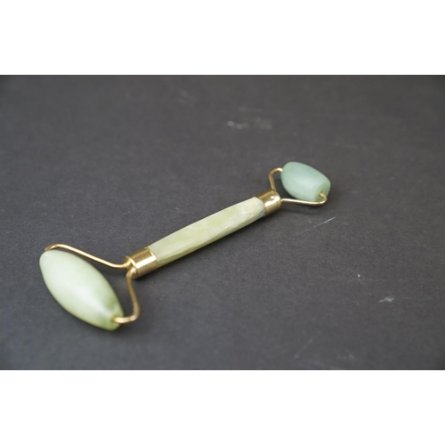 293 - A oriental Jade double ended roller with brass mounts together with a Jade handle.