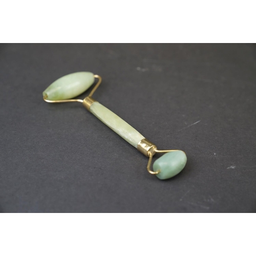 293 - A oriental Jade double ended roller with brass mounts together with a Jade handle.