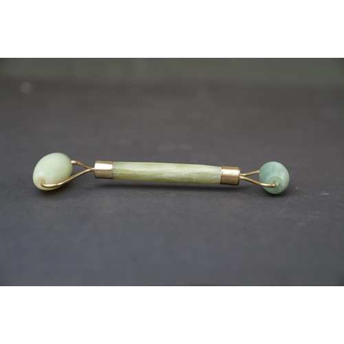 293 - A oriental Jade double ended roller with brass mounts together with a Jade handle.