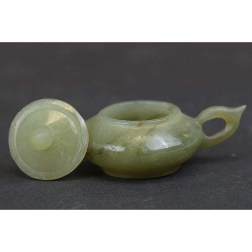 300 - A small collection of three oriental carved Jade ornaments to include a teapot, a seal and a mask on... 