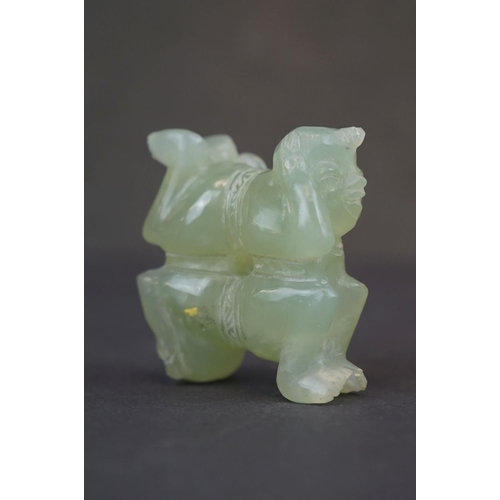 303 - A oriental carved Jade ornament of two circus performers.