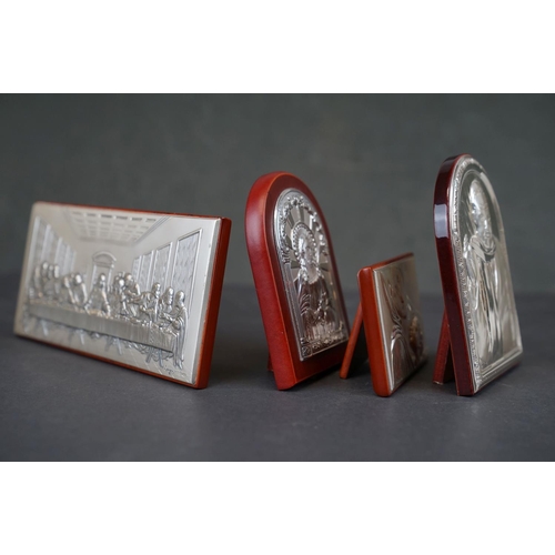 308 - A collection of four continental silver religious icons to include the last supper.