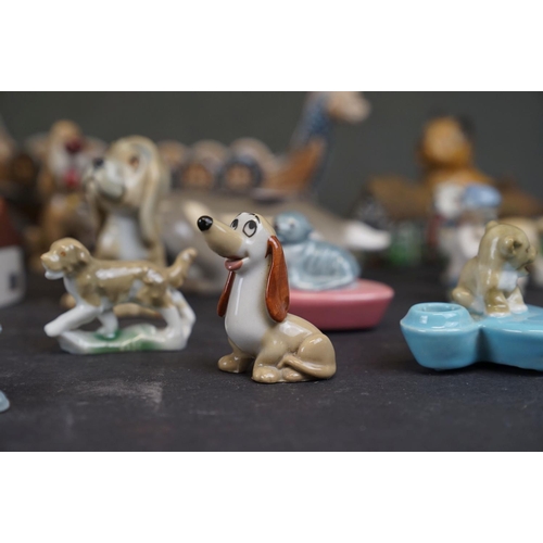 338 - A collection of Wade ceramic ornaments to include animals and houses together with other ceramics.