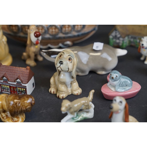 338 - A collection of Wade ceramic ornaments to include animals and houses together with other ceramics.