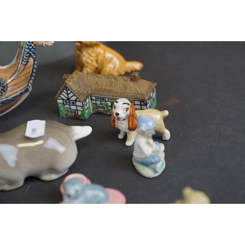 338 - A collection of Wade ceramic ornaments to include animals and houses together with other ceramics.