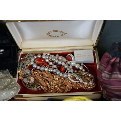 356 - A collection of mainly vintage costume jewellery contained within various display boxes.