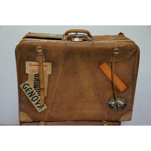 449 - Four vintage suitcases, to include demob example, others with travel stickers attached