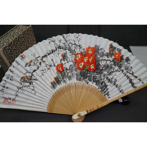 456 - A group of oriental collectables to include a fan and a carved wooden mask