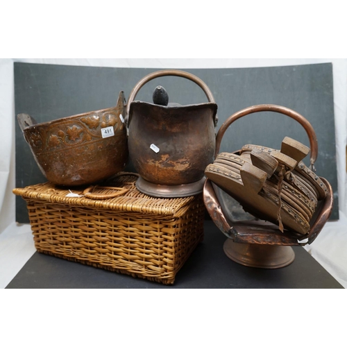 491 - Two vintage copper coal scuttles together with a copper coal bucket, bellows and a wicker basket.