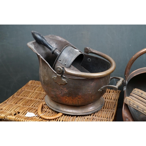 491 - Two vintage copper coal scuttles together with a copper coal bucket, bellows and a wicker basket.