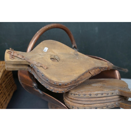 491 - Two vintage copper coal scuttles together with a copper coal bucket, bellows and a wicker basket.