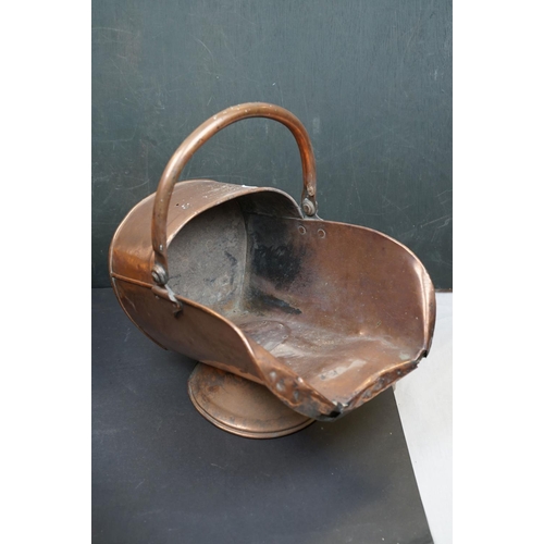 491 - Two vintage copper coal scuttles together with a copper coal bucket, bellows and a wicker basket.