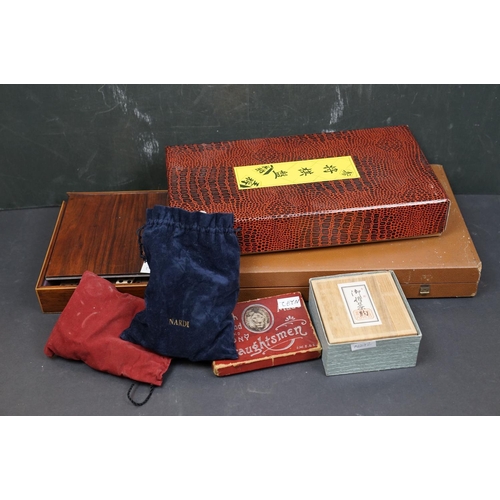 494 - A collection of vintage games to include Backgammon and bone dominos together with a set of rune sto... 