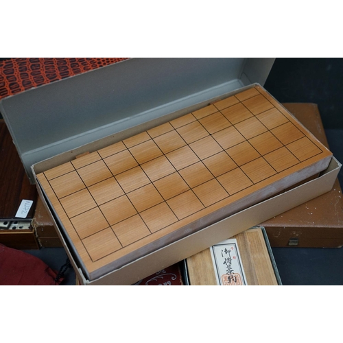 494 - A collection of vintage games to include Backgammon and bone dominos together with a set of rune sto... 