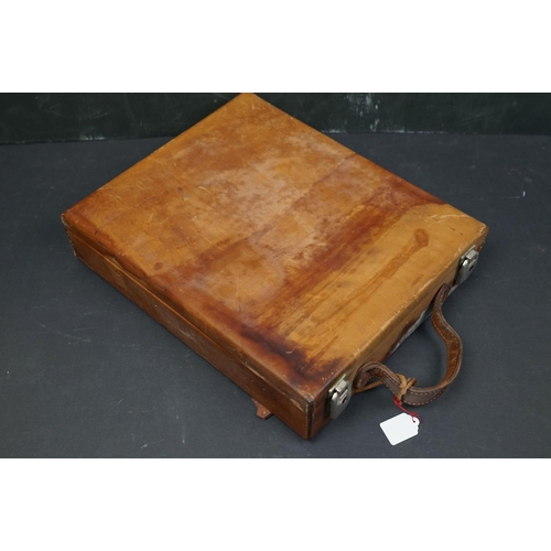 495 - A collection of leather collectables to include a vintage brief case, leather bound memo book, leath... 