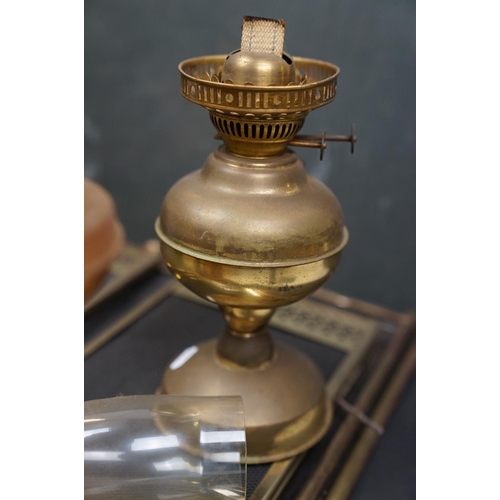 496 - Two vintage brass oil lamps together with two vintage fire guards.