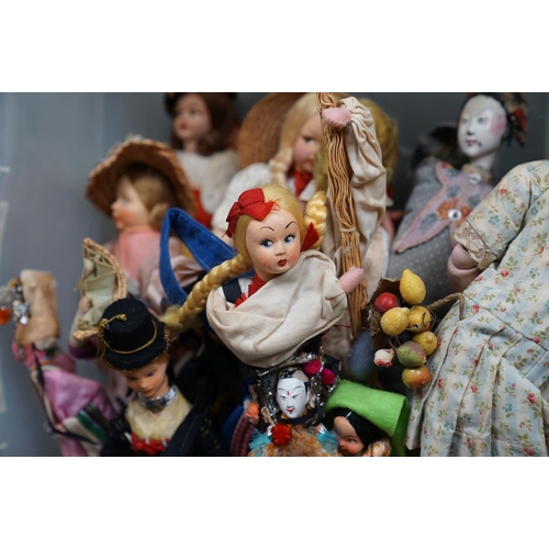 502 - A collection of vintage dolls to include ceramic examples.