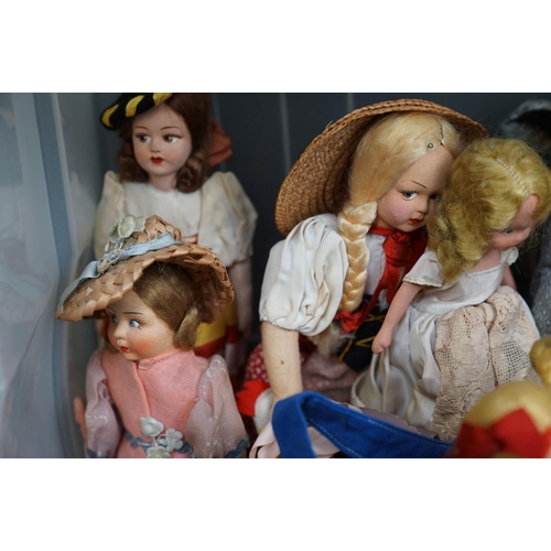 502 - A collection of vintage dolls to include ceramic examples.