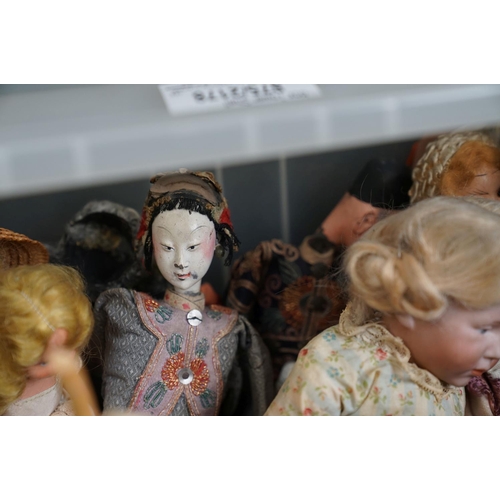 502 - A collection of vintage dolls to include ceramic examples.