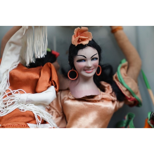 502 - A collection of vintage dolls to include ceramic examples.