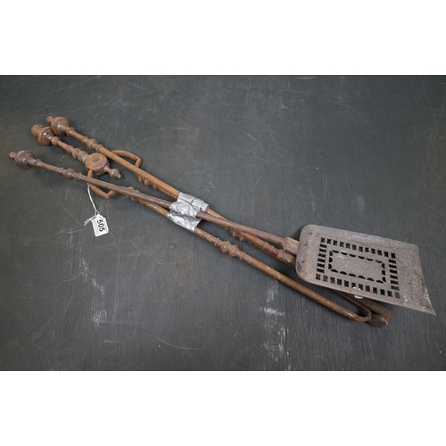 505 - A vintage iron three piece fire tool companion set comprising of shovel, poker and tongs.