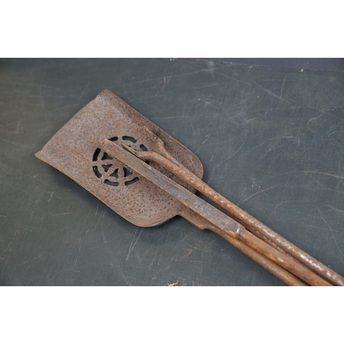 507 - A vintage iron three piece fire tool companion set comprising of shovel, poker and tongs.