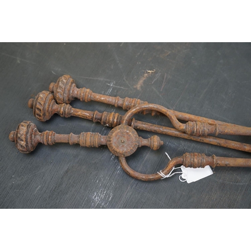 508 - A vintage iron three piece fire tool companion set comprising of shovel, poker and tongs.