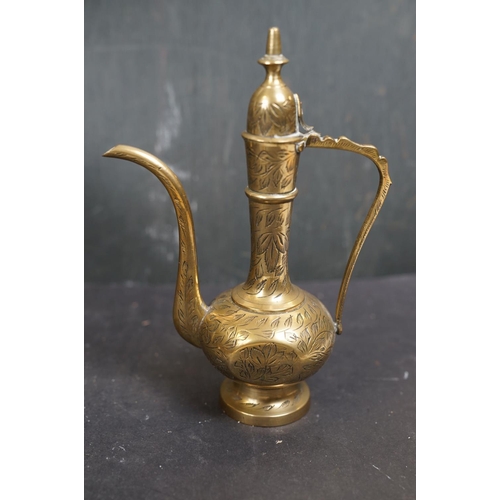 531 - A collection of assorted brass ware to include candlestick, letter rack and a watering can.