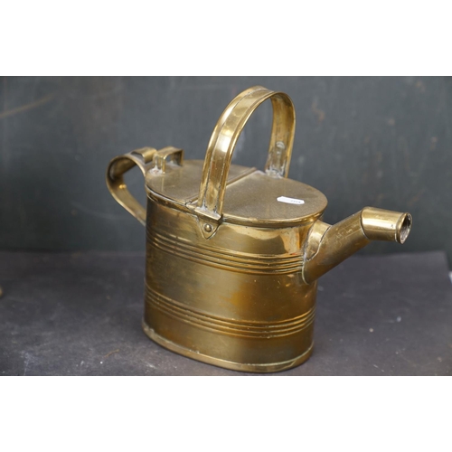 531 - A collection of assorted brass ware to include candlestick, letter rack and a watering can.