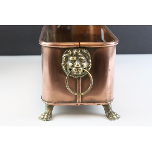 159 - Copper Rectangular Planter with Brass Lion Mask Ring Handles and raised on Four Brass Lion Paw Feet,... 