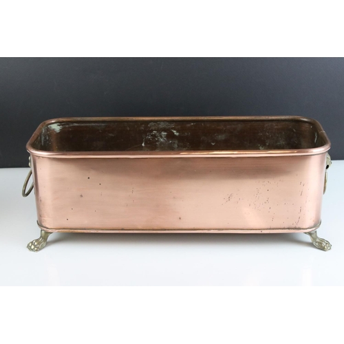 159 - Copper Rectangular Planter with Brass Lion Mask Ring Handles and raised on Four Brass Lion Paw Feet,... 