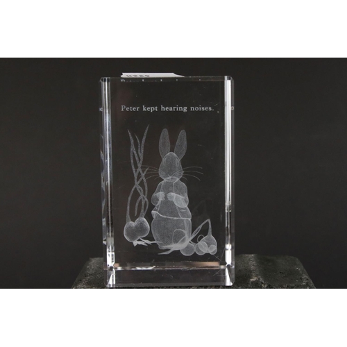 406 - A group of three clear glass paperweights, two with Beatrix Potter characters.