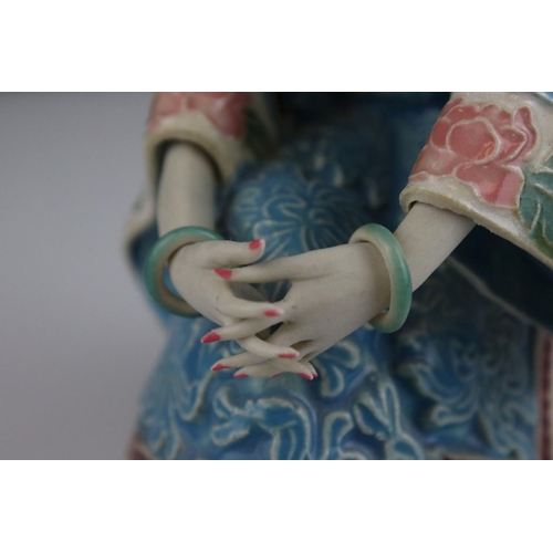 409 - An Oriental Shi Wan ceramic pottery figure of  a seated  lady.