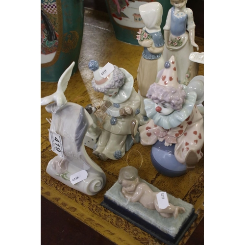 419 - A group of mainly Lladro figures to include Clowns and boy with teddy bear.