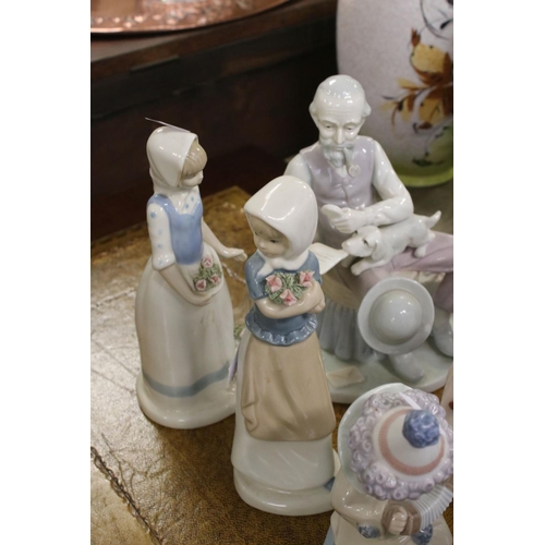 419 - A group of mainly Lladro figures to include Clowns and boy with teddy bear.