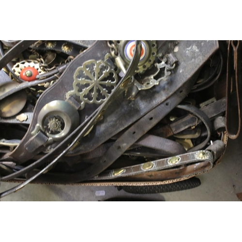 426 - A large collection of vintage horse brasses with leather straps.