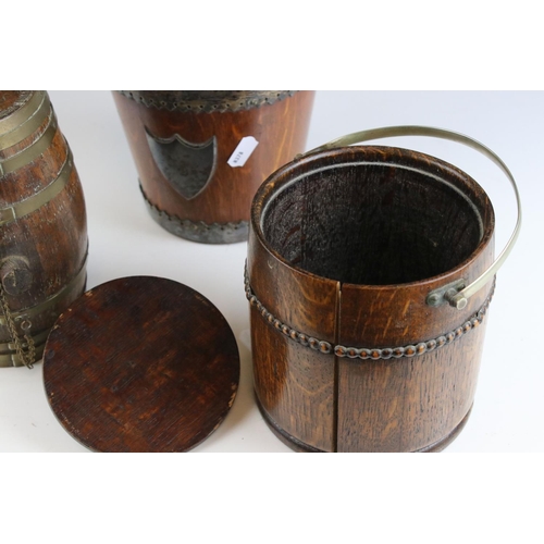 429 - A group of three wooden collectables to include a biscuit barrel, a tea caddy and a brass bound keg.