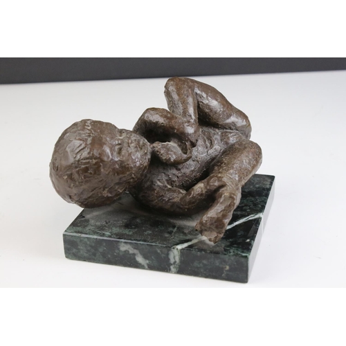 434 - A bronzed resin sculpture of a baby playing.