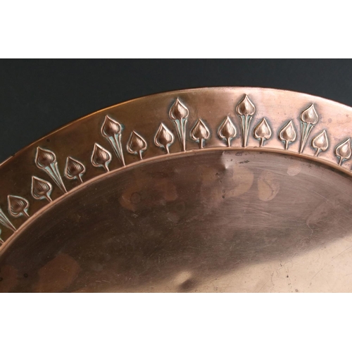 435 - A copper arts and craft tray with tulip detail to the edge together with a glass decanter.