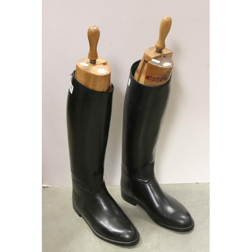 444 - A pair of Aigle riding boots with wooden boot trees.