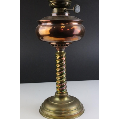 445 - An early 20th century brass and copper oil lamp complete with glass shade and chimney.