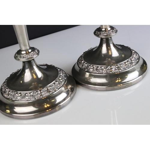 475 - A pair of silver plated antique style candlesticks .