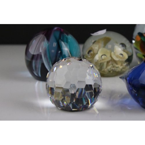 513 - A collection of seven glass paperweights to include Caithness examples.