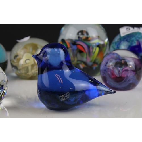 513 - A collection of seven glass paperweights to include Caithness examples.