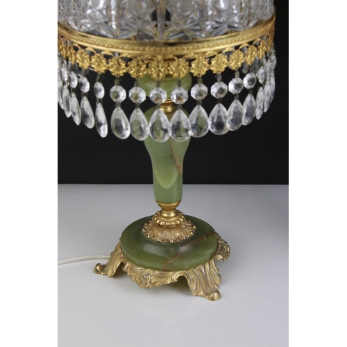 518 - A pair of green alabaster table lamps with gilt decoration and glass shades.