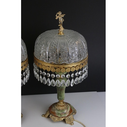 518 - A pair of green alabaster table lamps with gilt decoration and glass shades.